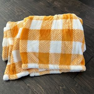Orange and white plaid plush throw blanket